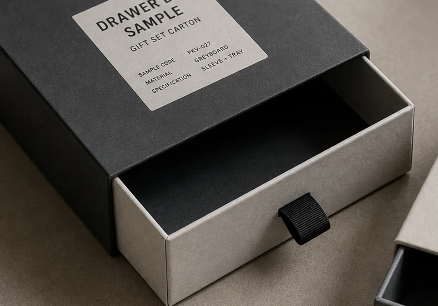 Rigid drawer box sample with partially pulled tray, ribbon tab, and specification label