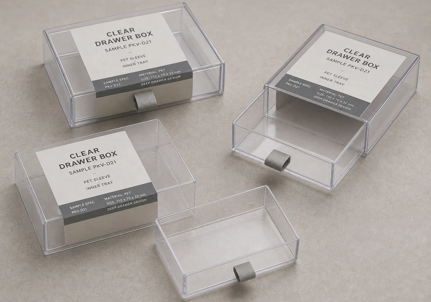 Clear plastic drawer box samples with sliding trays, pull tabs, and printed insert cards